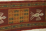 Hand woven ceremonial Sumba Hinggi Ikat Songket Textile 55"x 13.25" Geometric Designs. Handspun Cotton Tapestry, Dyed with Natural Pigments. Adorned with Symbolic Insect Motifs Created with Hand sewn tiny Nassa Shells (SR26) red rust background
