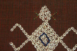 Hand woven ceremonial Sumba Hinggi Ikat Songket Textile 55"x 13.25" Geometric Designs. Handspun Cotton Tapestry, Dyed with Natural Pigments. Adorned with Symbolic Insect Motifs Created with Hand sewn tiny Nassa Shells (SR26) red rust background