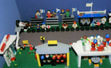 UNIQUE HUGE CUSTOM LEGO SET (1032 PCS): 41 MINIFIGURES (YEAR 1978 & ON), RACE TRACK, FINISH LINE, MULTIPLE BLEACHERS, 6 CARS, SNACK BAR, HELMET SHOP, GAS PUMP, AMBULANCE, REPORTERS, HOT DOG CART, MULTIPLE ACCESSORIES ETC... (KIT 10) 32" X 12"