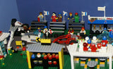 UNIQUE HUGE CUSTOM LEGO SET (1032 PCS): 41 MINIFIGURES (YEAR 1978 & ON), RACE TRACK, FINISH LINE, MULTIPLE BLEACHERS, 6 CARS, SNACK BAR, HELMET SHOP, GAS PUMP, AMBULANCE, REPORTERS, HOT DOG CART, MULTIPLE ACCESSORIES ETC... (KIT 10) 32" X 12"