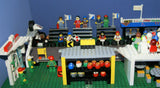UNIQUE HUGE CUSTOM LEGO SET (1032 PCS): 41 MINIFIGURES (YEAR 1978 & ON), RACE TRACK, FINISH LINE, MULTIPLE BLEACHERS, 6 CARS, SNACK BAR, HELMET SHOP, GAS PUMP, AMBULANCE, REPORTERS, HOT DOG CART, MULTIPLE ACCESSORIES ETC... (KIT 10) 32" X 12"