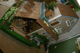 1970 HUGE CUSTOM BUILT & FULLY FURNISHED DOLL HOUSE (5 ft x 4ft x 32”) WITH 14 rooms & 3 gardens, Plants, Trees + Outhouse (1/12 Scale) Operating Lights