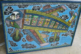 RARE UNIQUE COLORFUL  FOLK ART PAINTING PAPUA NEW GUINEA HUMOROUS ARTIST: TRIBAL WARRIORS TRAVELLING BY AIRPLANE & FRAMED IN SIGNED HAND PAINTED FRAME TO MATCH THE ART DESIGNER COLLECTOR WALL CARTOON  ART  42” by 30 1/2”HUGE DFP11