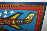 RARE UNIQUE COLORFUL  FOLK ART PAINTING PAPUA NEW GUINEA HUMOROUS ARTIST: TRIBAL WARRIORS TRAVELLING BY AIRPLANE & FRAMED IN SIGNED HAND PAINTED FRAME TO MATCH THE ART DESIGNER COLLECTOR WALL CARTOON  ART  26 1/2” by 23 1/2” HUGE DFP8