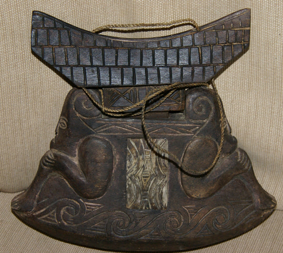 HAND CARVED WOODEN BETEL QUID CONTAINER PURSE, TORAJA PEOPLE, SULAWESI.  BETEL LIME HABIT RECEPTACLE WITH MOTIFS OF ANCESTORS & BUFFALO BONE DECORATIONS CREATED IN THE SHAPE OF TRADITIONAL TONGKONAN HOUSES. COLLECTED IN THE FIELD